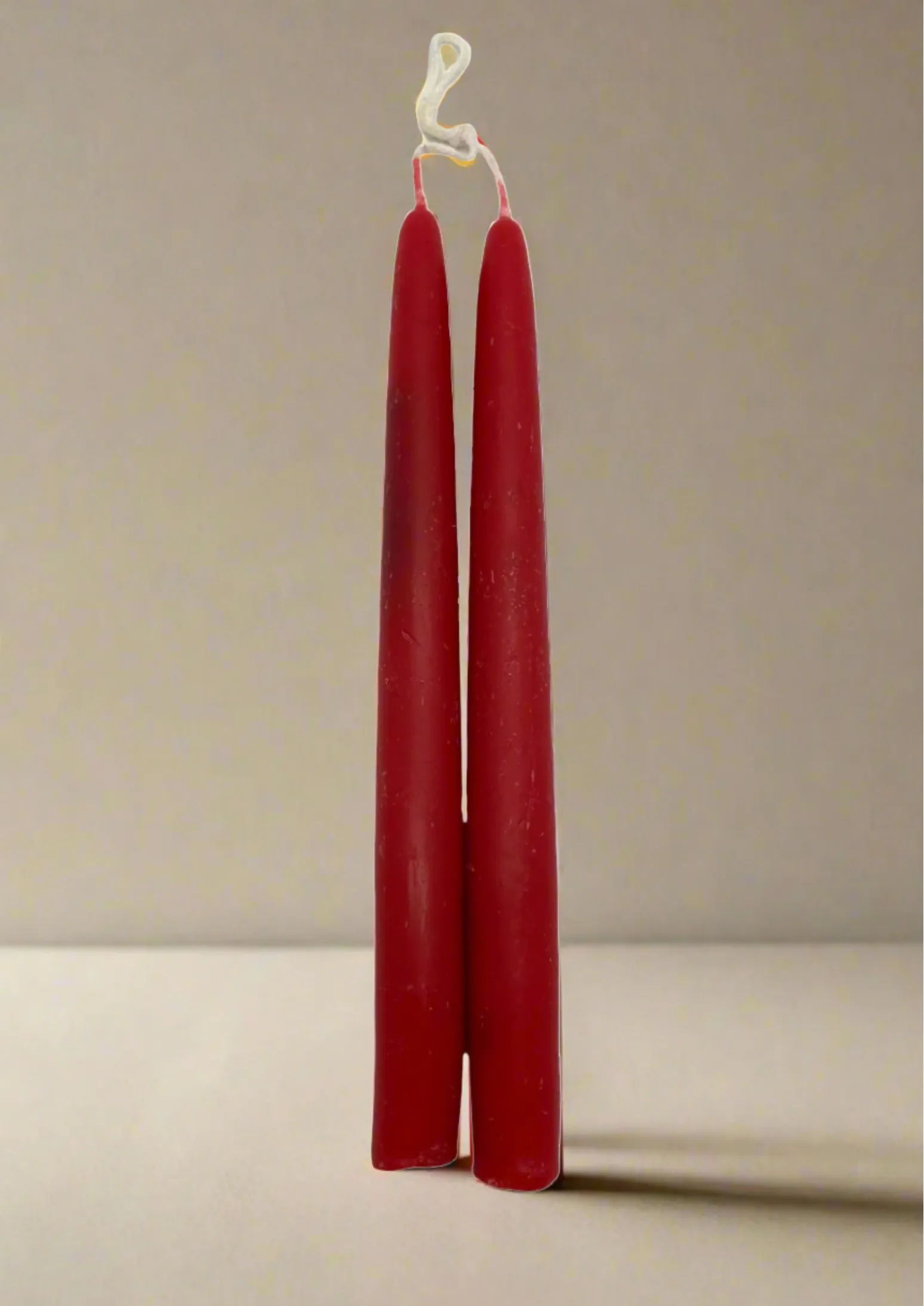 Pair of beeswax dipped red candles (OL)